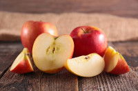 Des pommes entières et en quartier posées sur une table