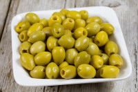 Une assiette contenant des olives vertes dénoyautées