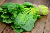 Un bouquet d'épinards sur une table en bois