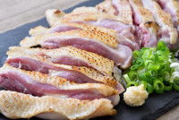 Des morceaux de poulet cru avec la peau dans une assiette