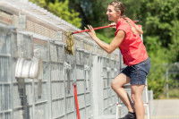 Une bénévole nettoie les box dans un refuge pour chiens
