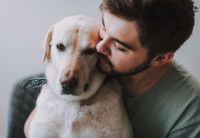 Un homme fait un câlin à son chien