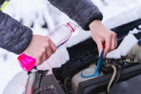 Un homme met de l'antigel dans sa voiture